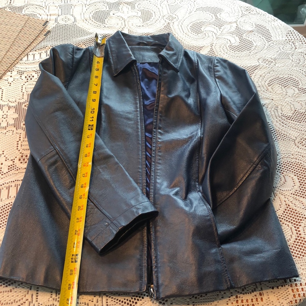 Women’s zip Navy blue leather jacket.